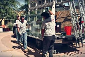 Glass King repair crew unloading glass off of a glass truck working on a commercial glass repair job in Chandler AZ
