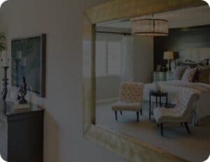 A mirror in a bedroom, serving as a functional and decorative piece that can enhance natural light and create an illusion of space.