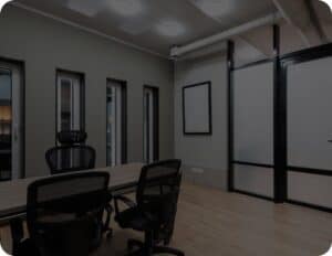 A conference room with a table, chairs, and a window.