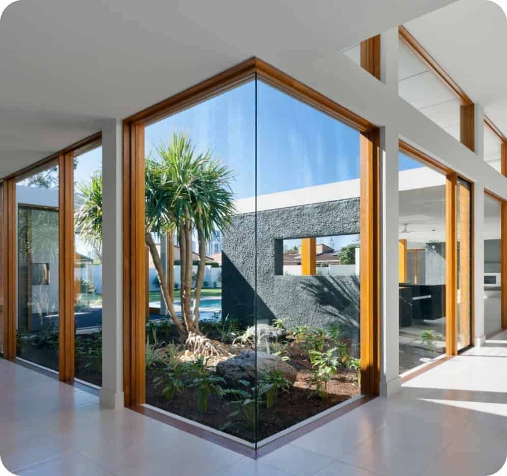 A contemporary house with glass doors and a beautiful garden.